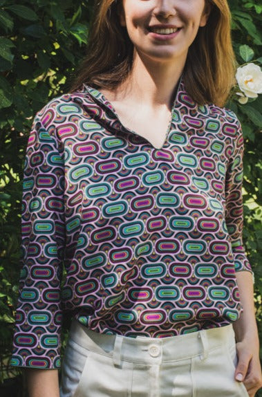 Tea shirt with oval pattern on a pink silk background